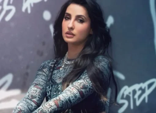 Nora Fatehi smiling, possibly in a vibrant, summery outfit, ready to slay.