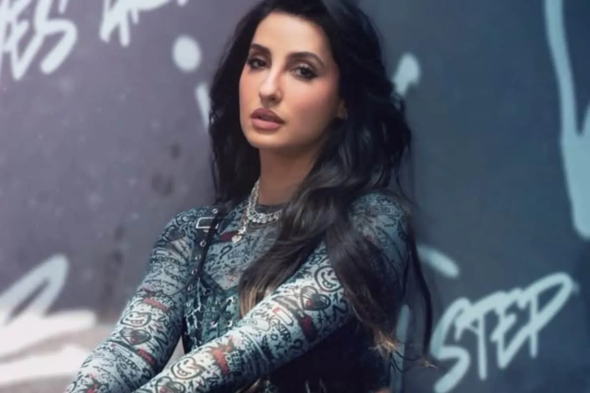 Nora Fatehi smiling, possibly in a vibrant, summery outfit, ready to slay.
