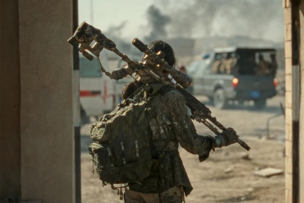 An intense scene featuring a female sniper in action, with dramatic lighting and a serious tone.