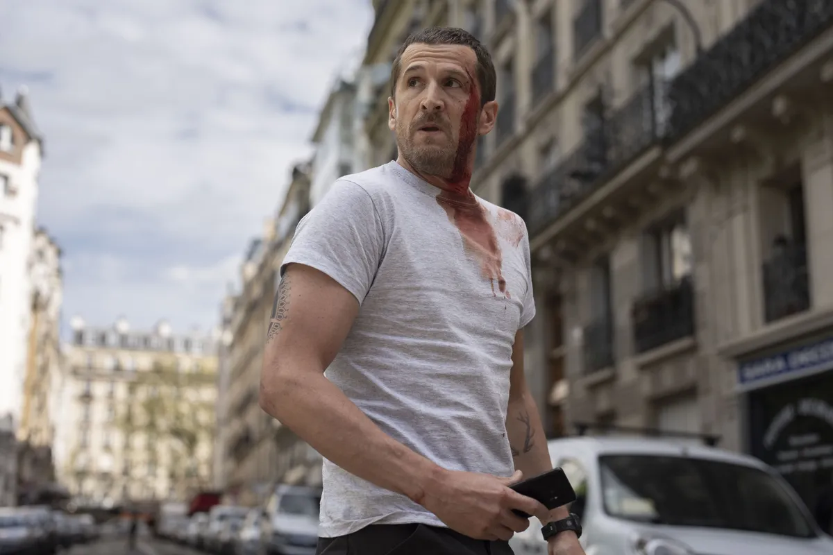 Guillaume Canet with an intense expression, looking ready for action, from the film Ad Vitam.