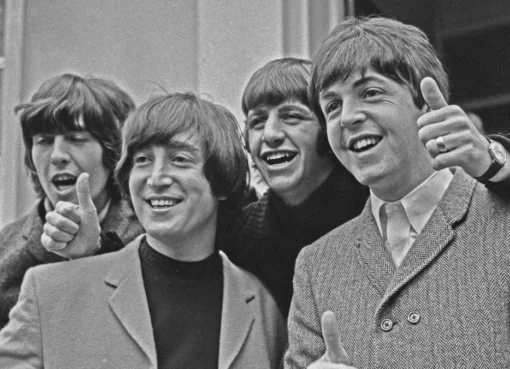 Drone footage showing the recreation of The Beatles' Abbey Road album cover on a street.