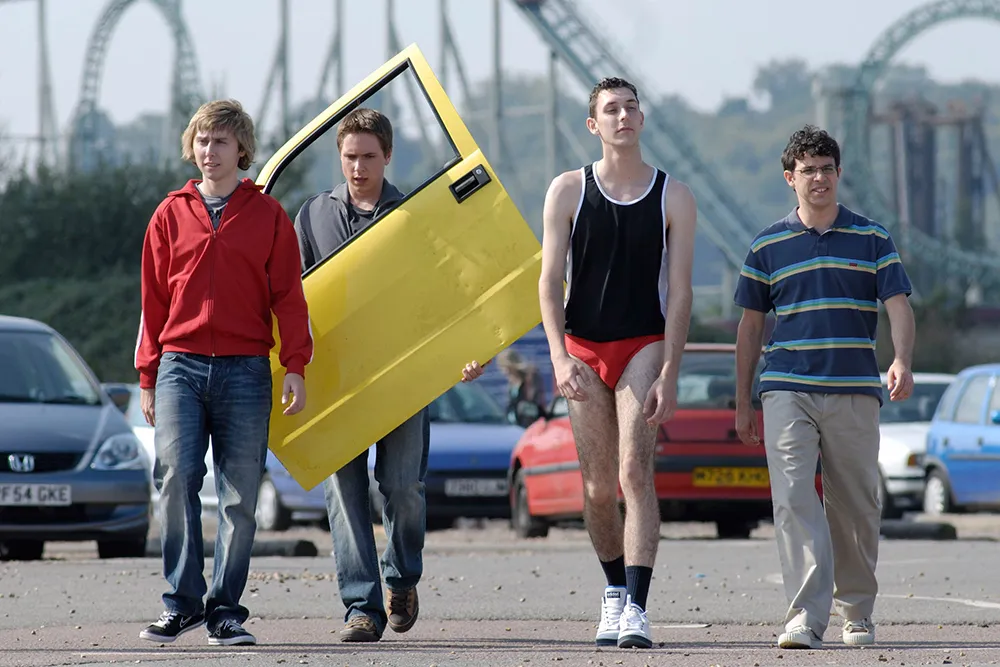 The four main cast members of The Inbetweeners smiling for a photo.