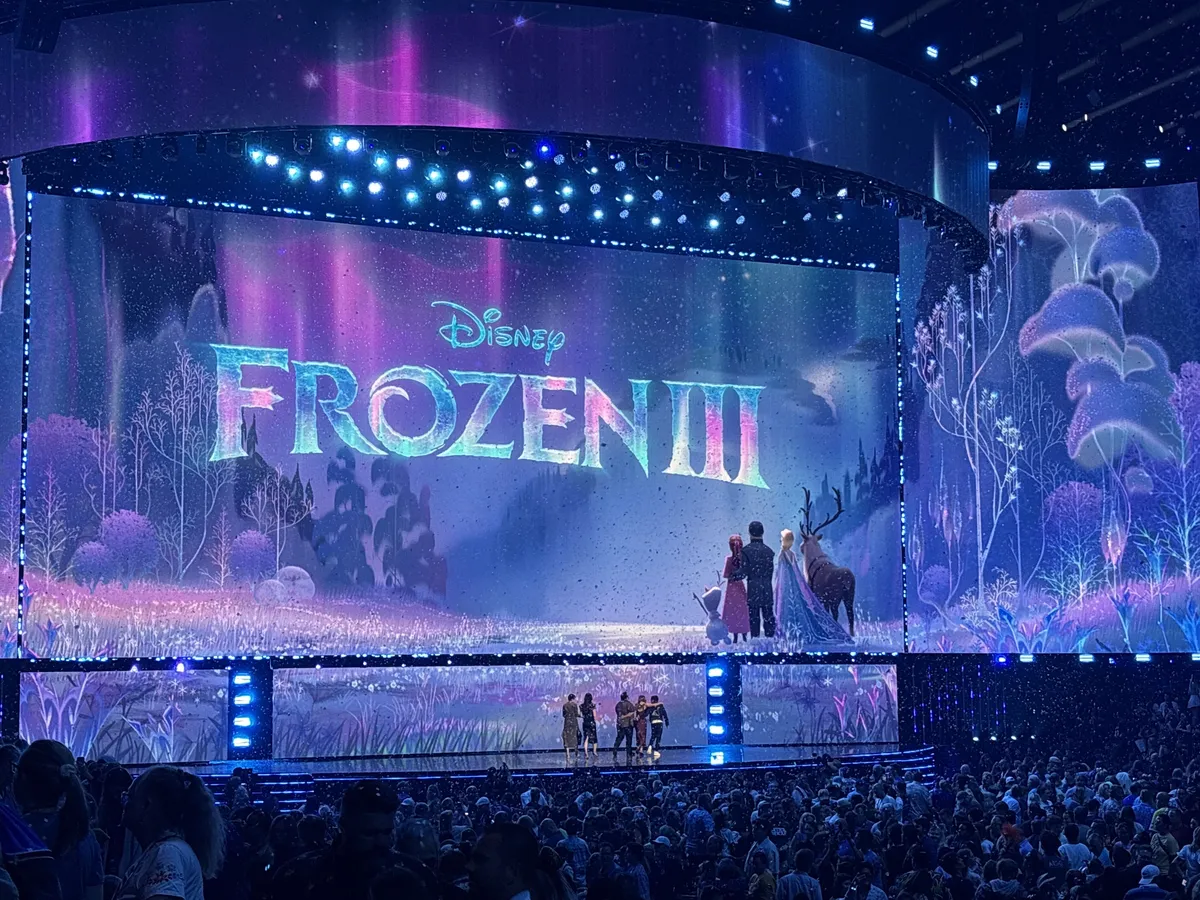 Anna and Kristoff from Frozen smiling warmly in a snowy Arendelle setting, with Elsa and Olaf nearby.