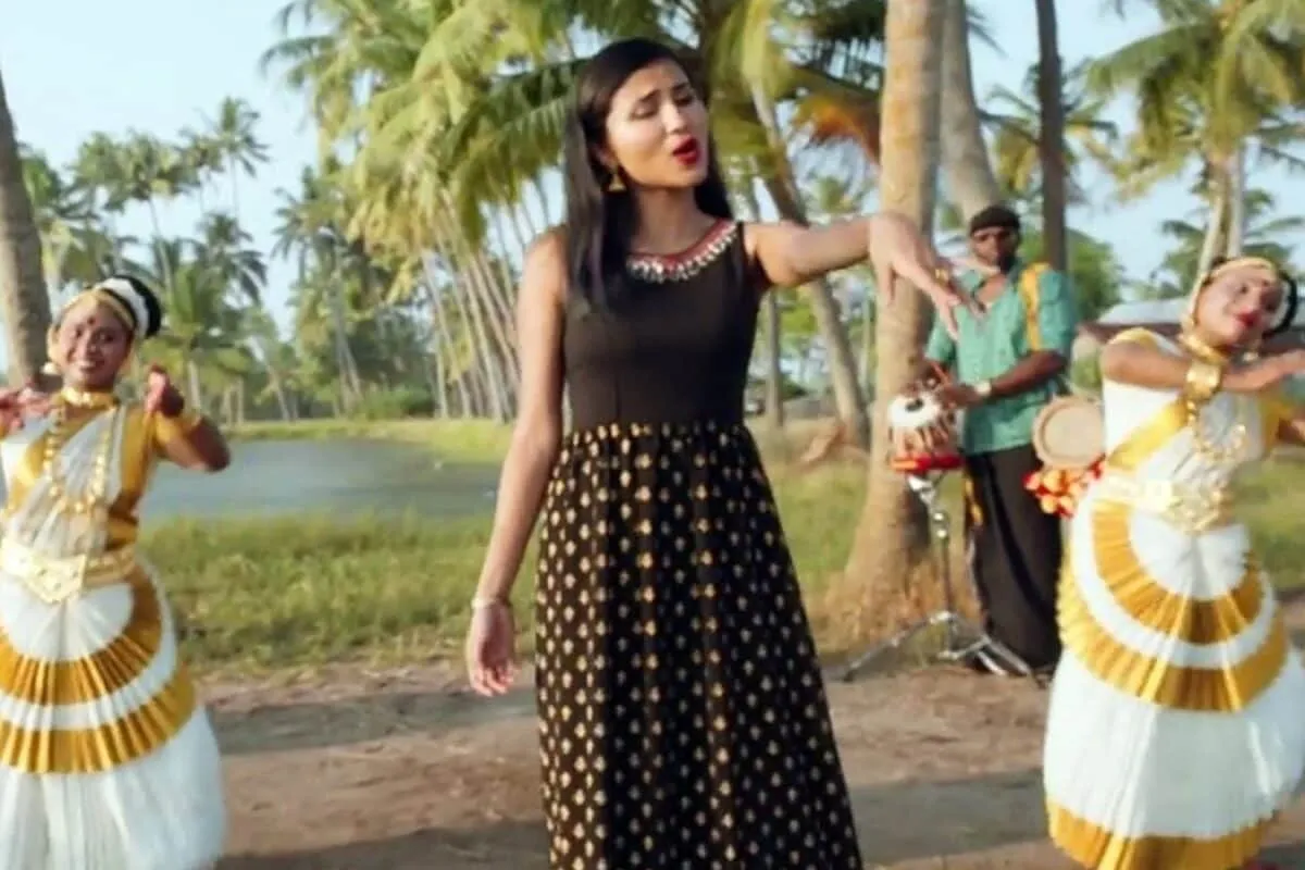 A group of people celebrating Onam with traditional decorations and music.