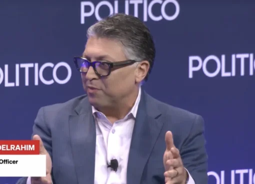 A person speaking at a podium at a conference.
