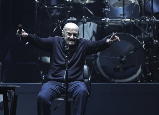 A close up photo of Phil Collins looking thoughtful