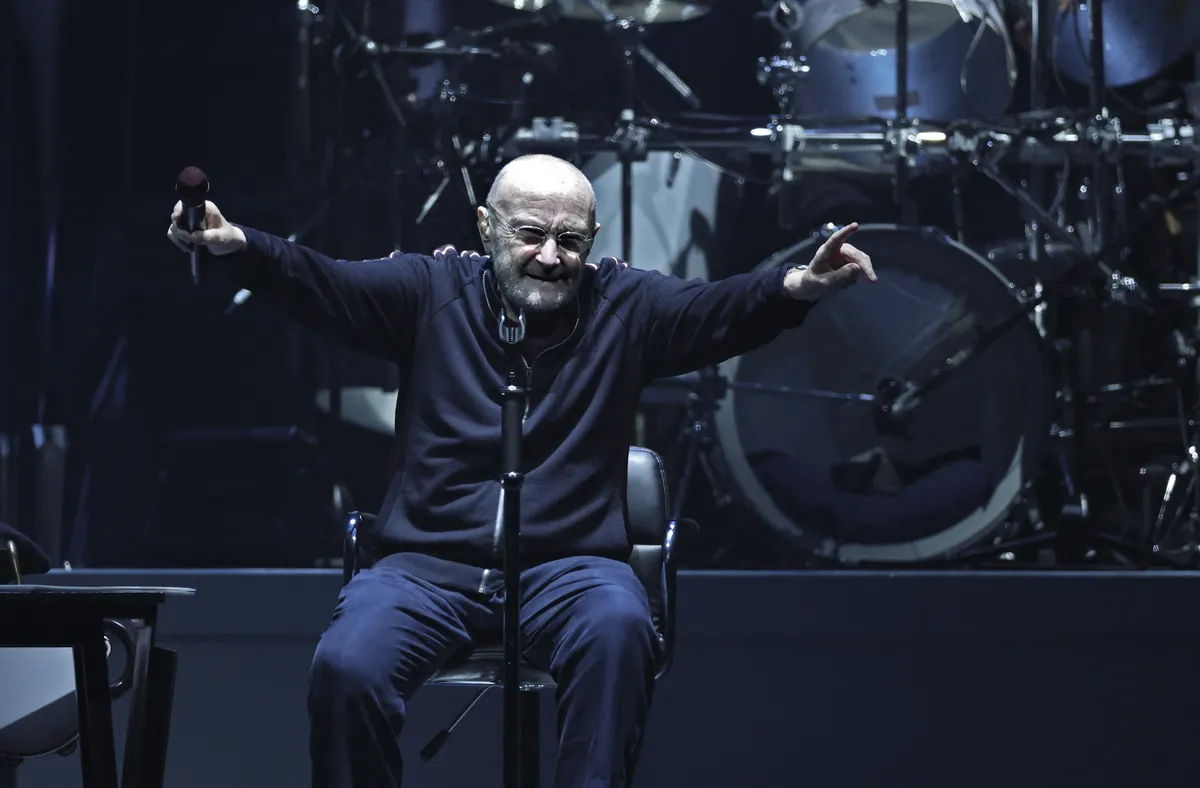 A close up photo of Phil Collins looking thoughtful