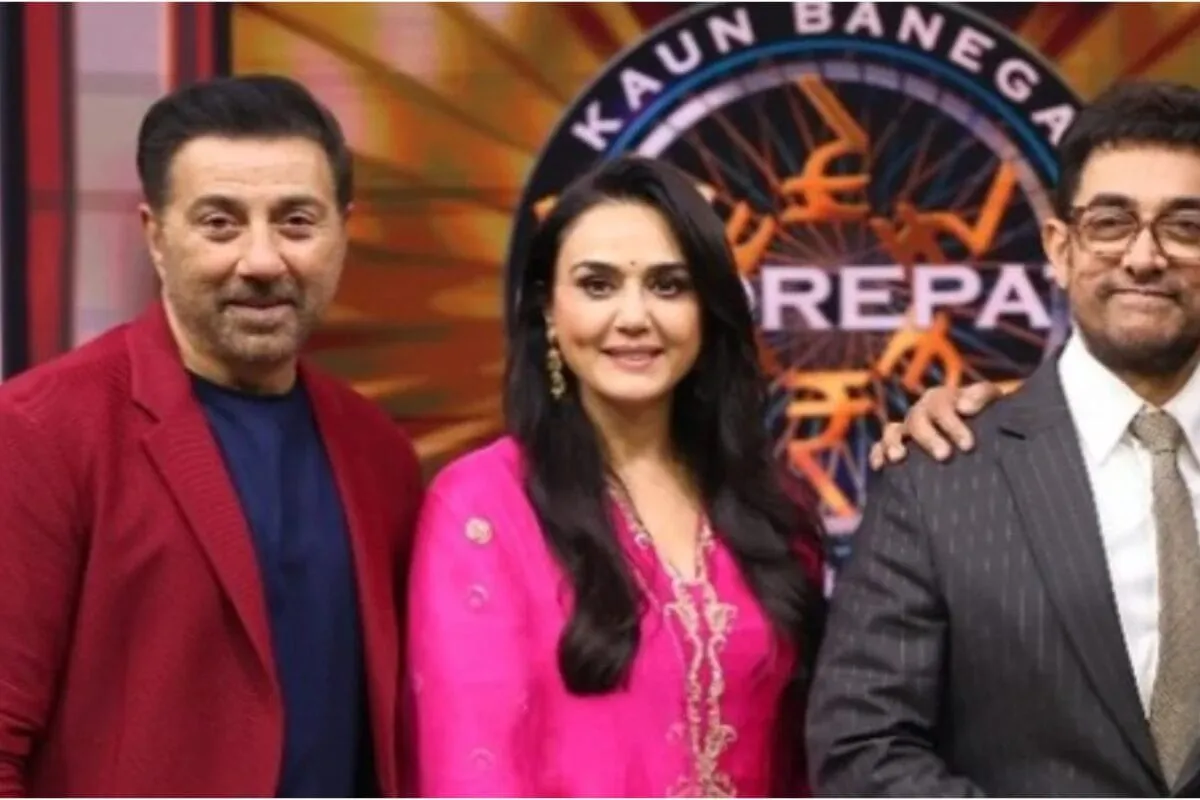 Preity Zinta and Aamir Khan smiling and interacting at an event.