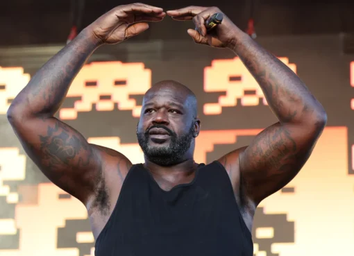 Shaquille O'Neal smiling, perhaps in a superhero pose or with a basketball.
