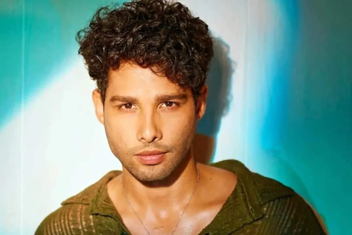 Siddhant Chaturvedi looking happy, possibly in a stylish setting.