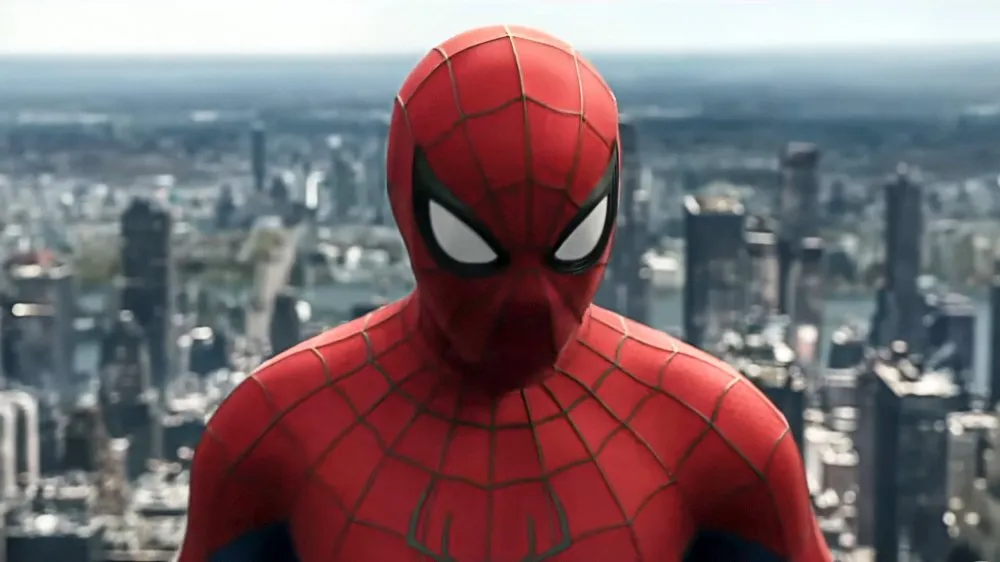 Three Spider-Men (Tom Holland, Andrew Garfield, Tobey Maguire) standing together.