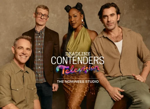 A group of Survivor cast and creatives smiling at a studio event, likely discussing the show.
