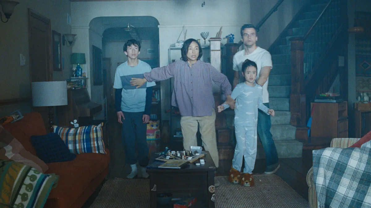 A family looking scared inside their home.