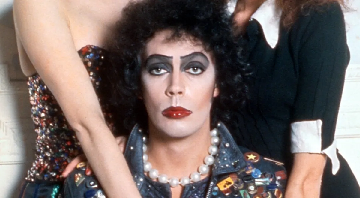Tim Curry in a theatrical pose, embodying his unique, playful acting style.