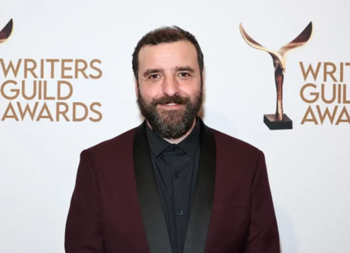 David Krumholtz smiling brightly, possibly at an event or on a set.