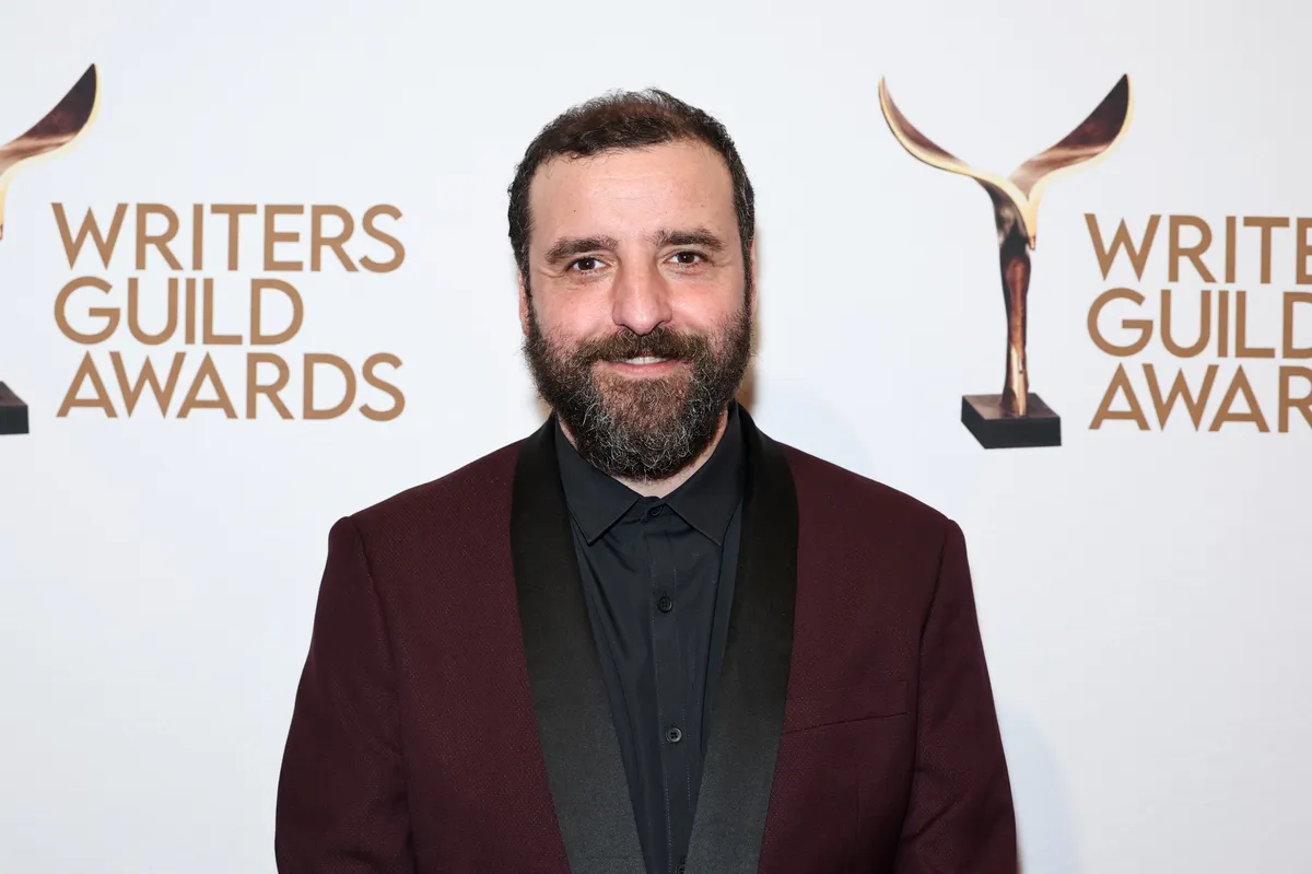 David Krumholtz smiling brightly, possibly at an event or on a set.