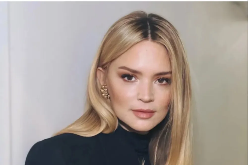Virginie Efira smiling and looking elegant at a film festival event.