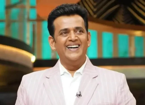 Ravi Kishan speaking to reporters with a microphone.