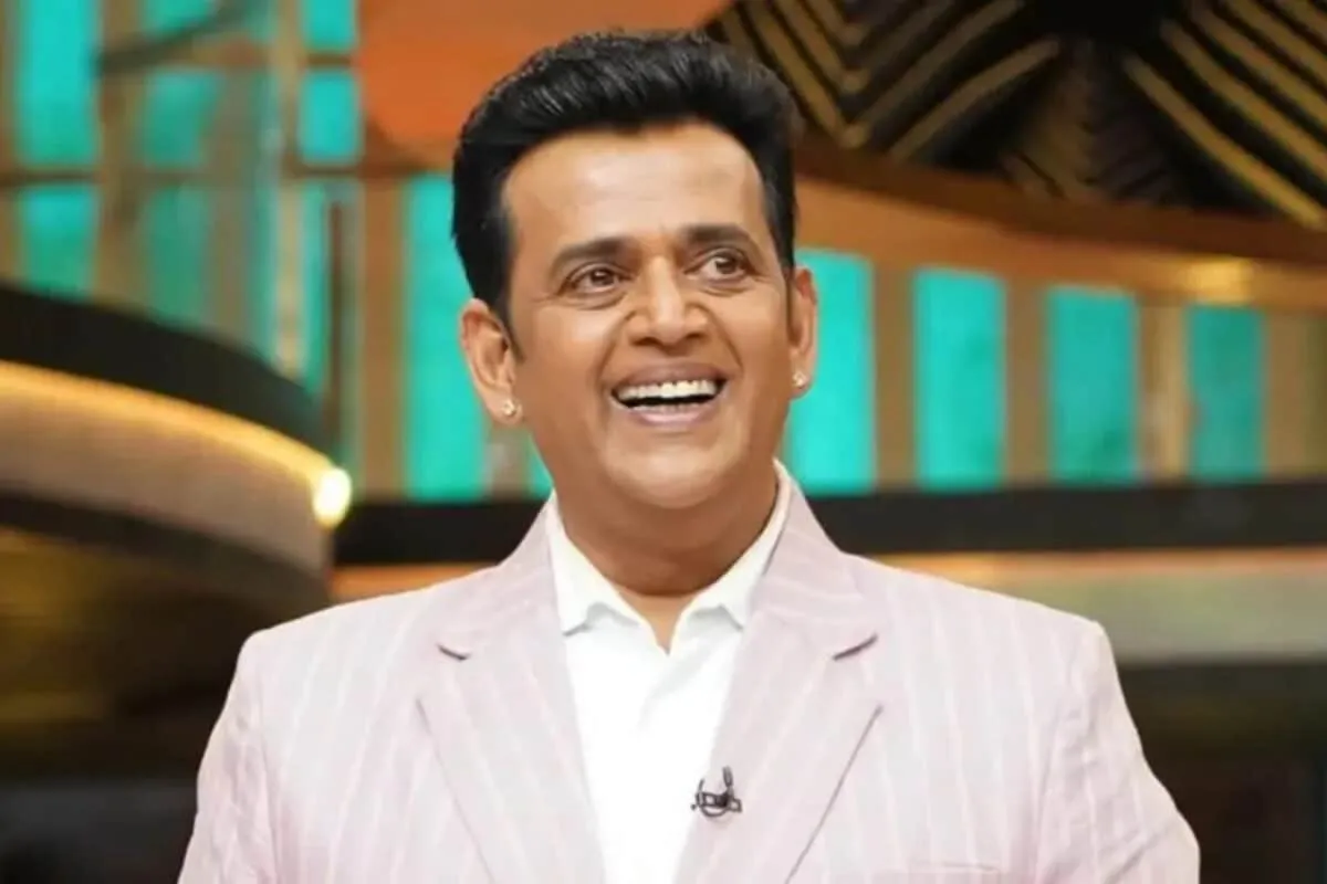 Ravi Kishan speaking to reporters with a microphone.