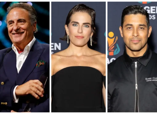 Andy Garcia, Karla Souza, and Wilmer Valderrama smiling on a red carpet at an awards show.