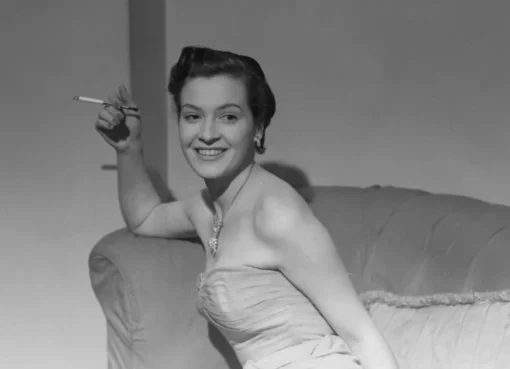 A smiling black and white headshot of Jean Lodge, a beautiful older woman with soft hair, from her younger acting days.