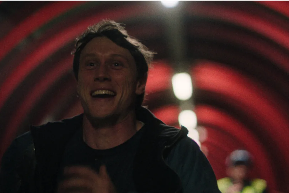 George MacKay looking intensely at the camera, conveying deep emotion.
