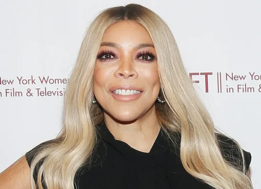 Wendy Williams smiling brightly on her talk show set.