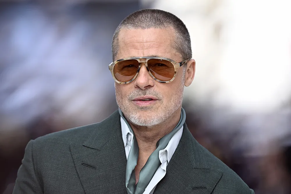 Brad Pitt smiling and looking thoughtful during an interview.