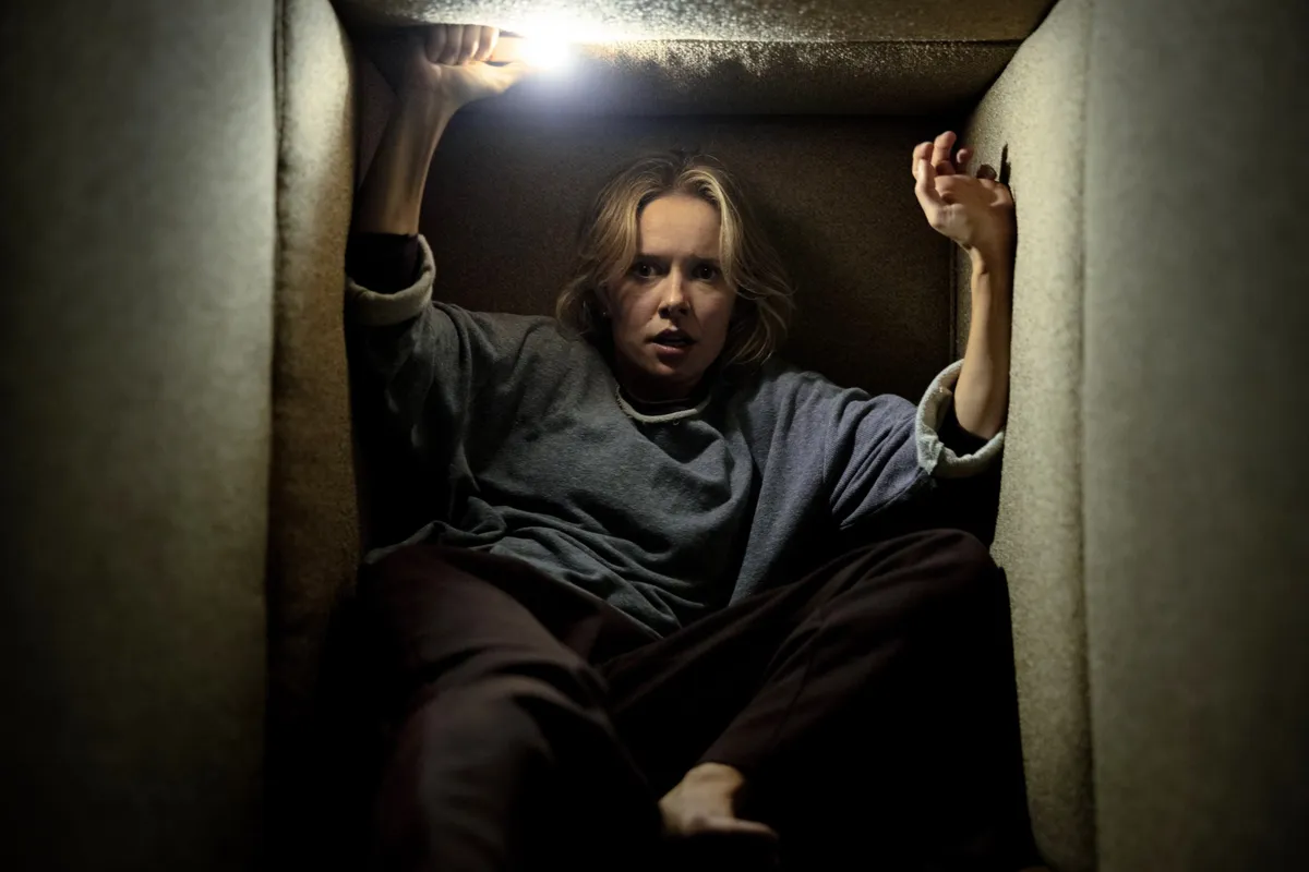 A movie poster for 'Insidious: Out of the Further' featuring a ghostly figure with a 'Spider-Man' logo subtly in the background.