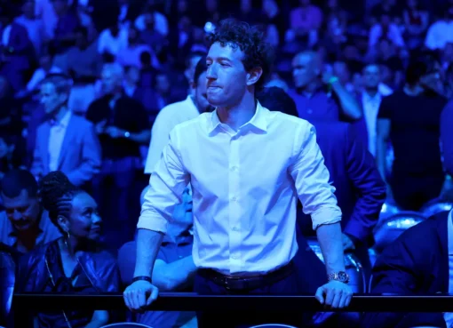 Mark Zuckerberg looking serious, with Meta logos in the background.