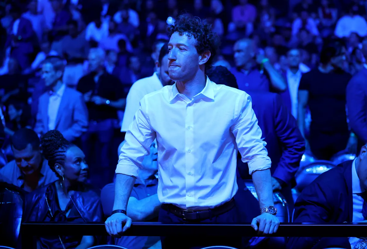 Mark Zuckerberg looking serious, with Meta logos in the background.