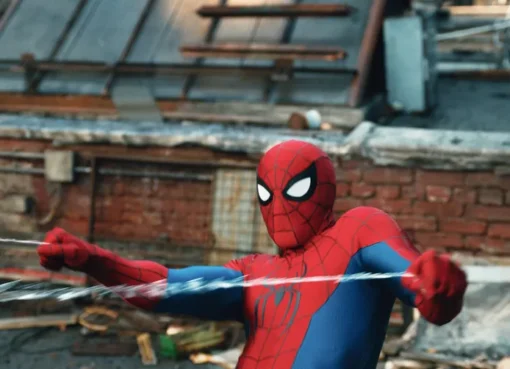 Spider-Man in his iconic red and blue suit, web-slinging through a city.