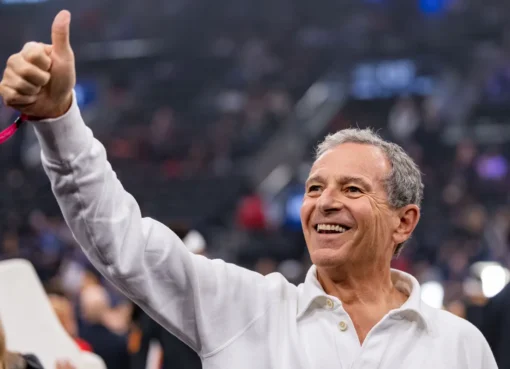 Bob Iger smiling, perhaps with a Lakers logo subtly in the background.
