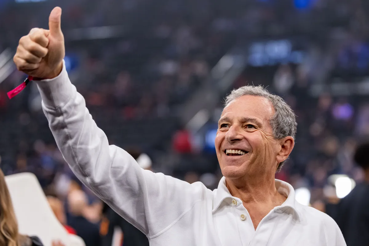 Bob Iger smiling, perhaps with a Lakers logo subtly in the background.