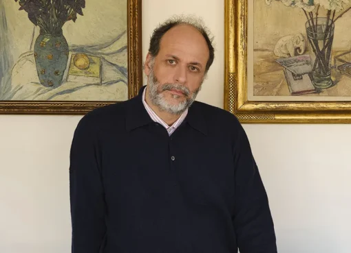 Italian director Luca Guadagnino smiling thoughtfully.