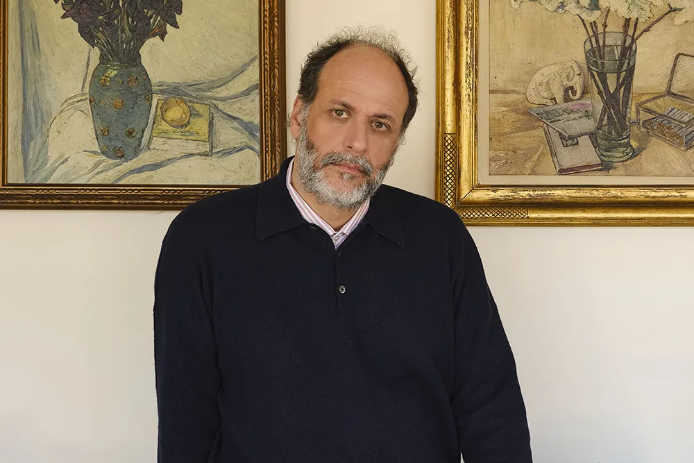 Italian director Luca Guadagnino smiling thoughtfully.
