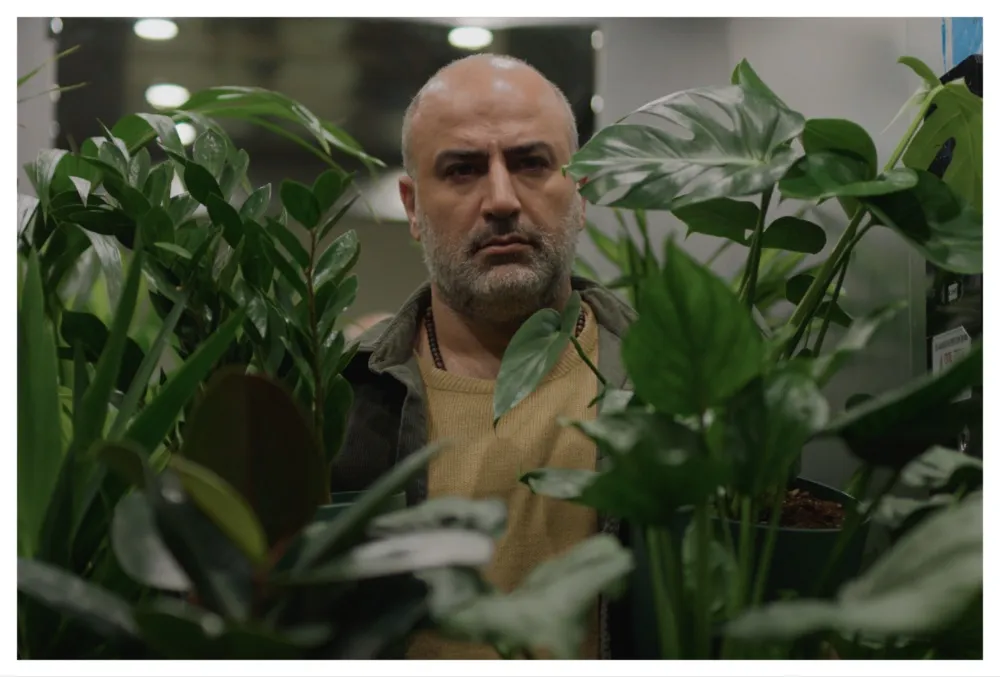 Still from the film 'A Bit of Light' showing two people talking intensely in a serious scene.