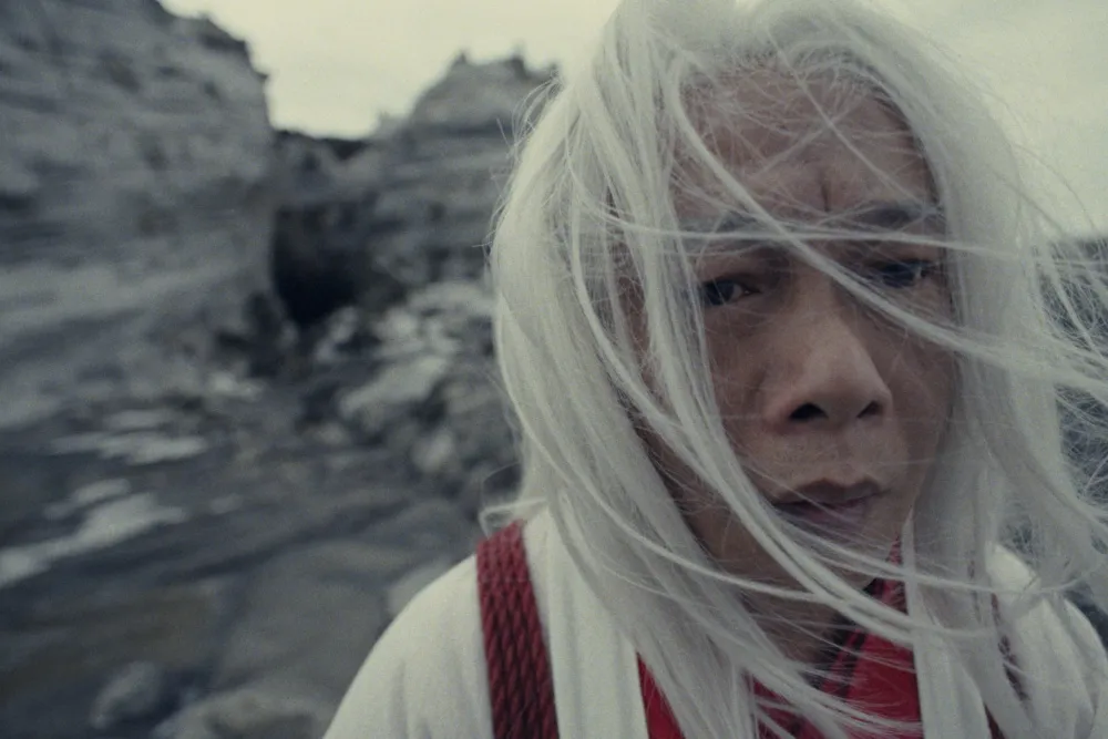 A still from 'The House on the Moon' showing a character in a mysterious, moonlit setting, hinting at graceful wuxia movements.