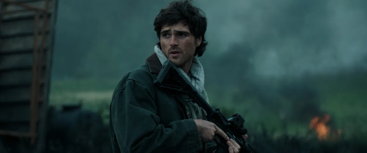 A movie poster showing a lone figure in a desolate landscape with a dog, conveying a post-apocalyptic feel.