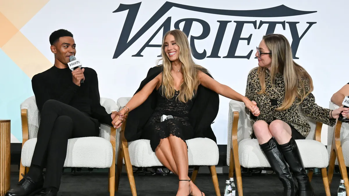 Executives and creators gather at a modern tech summit, possibly showing a panel discussion or networking.