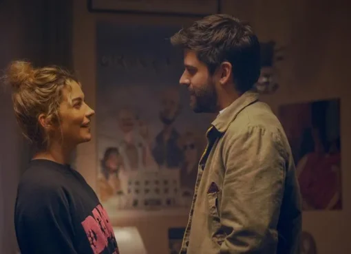 Annie Murphy and Cooper Raiff laughing together, looking like a well-matched romcom duo.