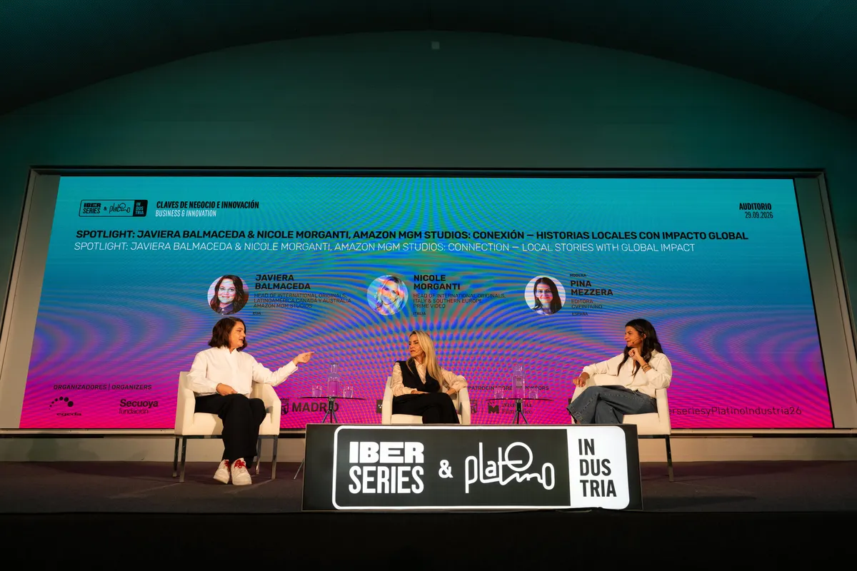 Two women talking on a stage at a film industry event