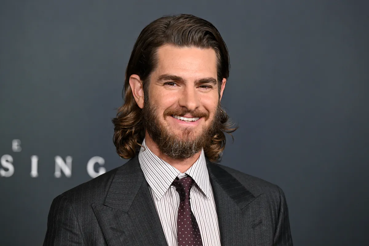 Andrew Garfield at a movie premiere, looking thoughtful.