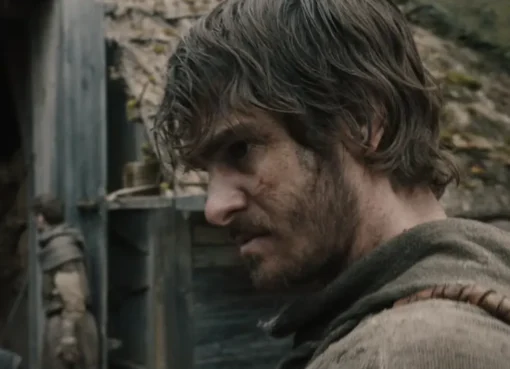 Andrew Garfield looking intense in a muddy medieval setting
