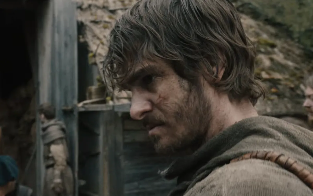 Andrew Garfield looking intense in a muddy medieval setting