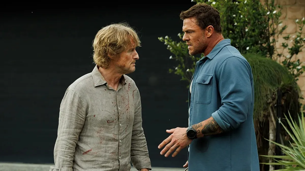 Owen Wilson and Alan Ritchson in a movie still from 'Runner', looking serious.