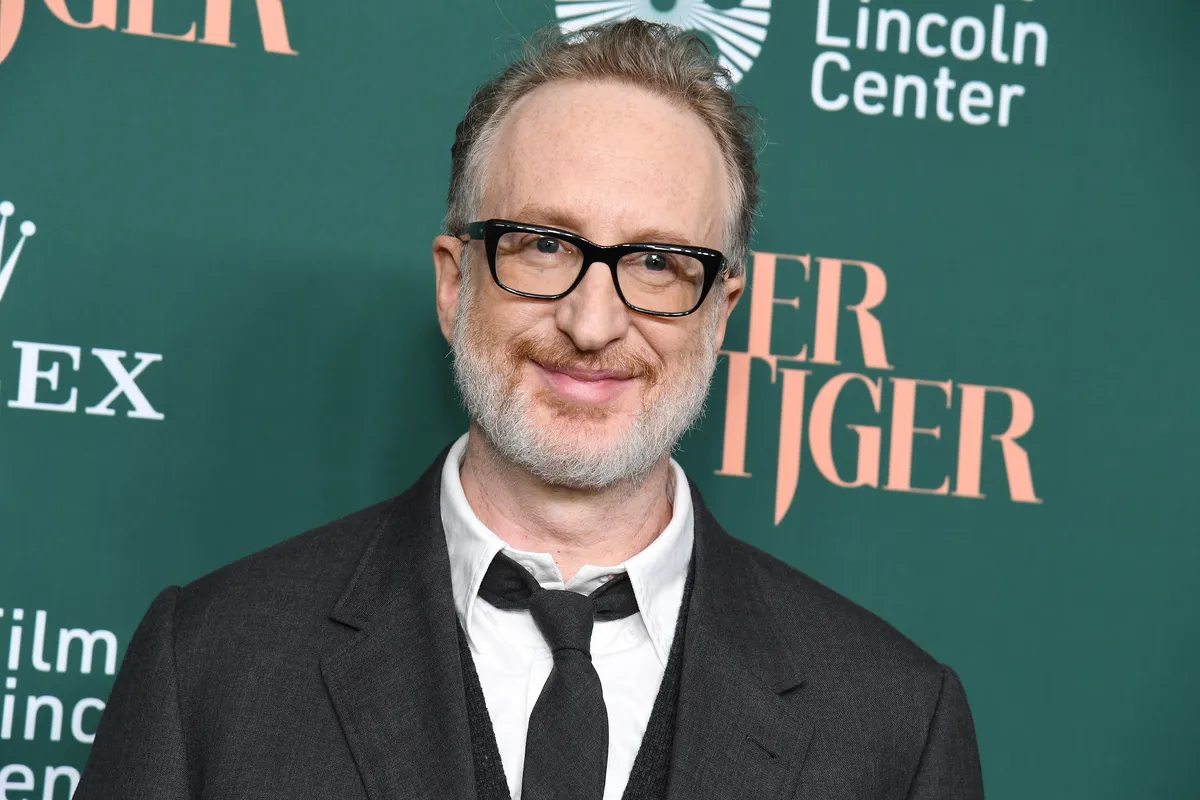 Director James Gray smiling thoughtfully during an interview.