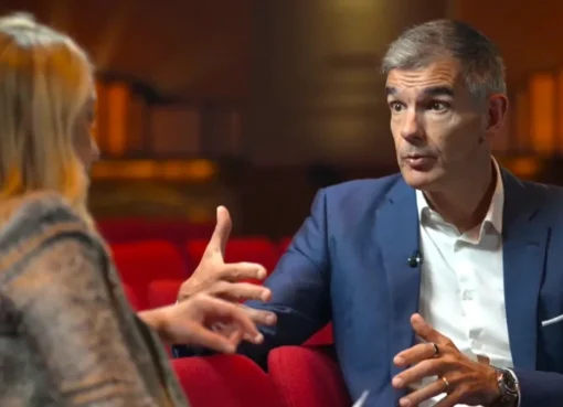 Matt Brittin, the director-general of the BBC, is speaking into a microphone during an interview.