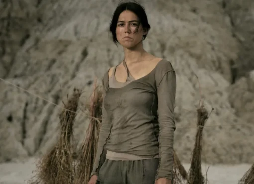 Nina Kiri in a still from the post-apocalyptic film 'Sanctuary' with a stark, muted color palette.