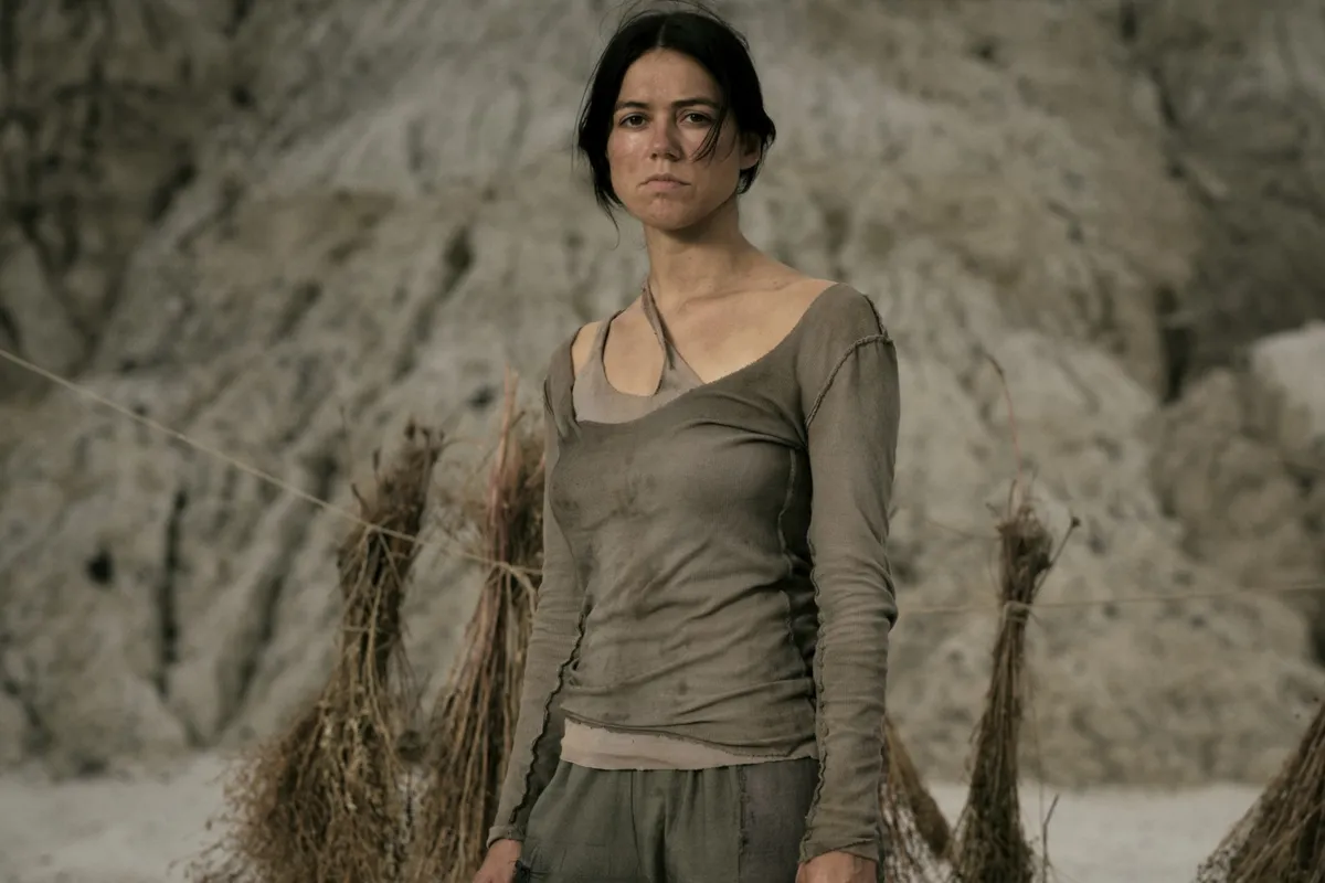 Nina Kiri in a still from the post-apocalyptic film 'Sanctuary' with a stark, muted color palette.